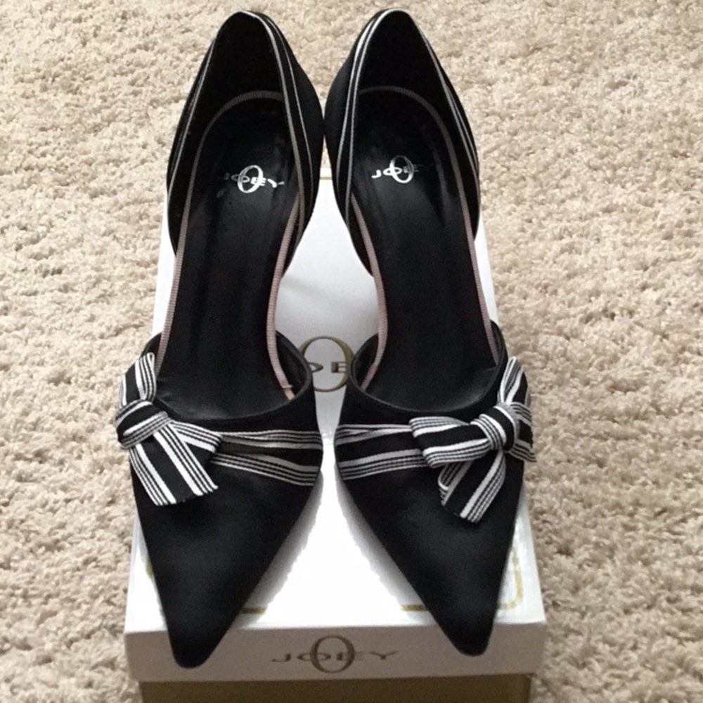 Black satin, black & white ribbon, leather lined & leather sole. Made in Spain.